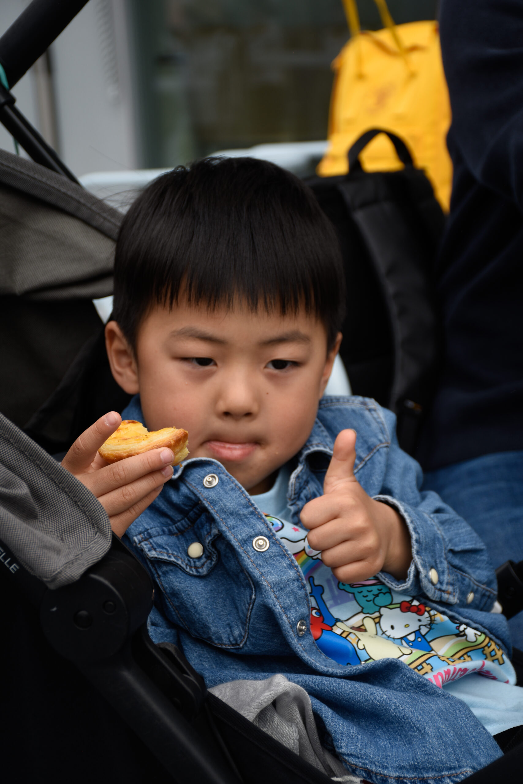Little boy eating a nata, pastel de nata, eggtart from Nata Pura at Expo 2025 Osaka
